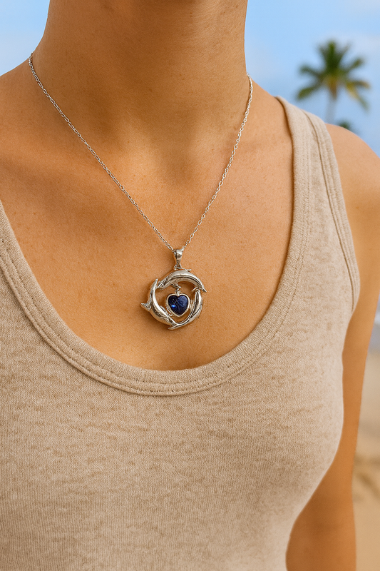 ✨🌊 “Dive into elegance 🐬💙 This silver dolphin trio pendant with a sparkling ocean-blue heart is the perfect symbol of love, freedom, and the sea.” 🌴💎